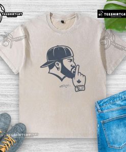 Vladimir Guerrero Jr. in a Toronto Blue Jays washed t-shirt, showcasing his iconic shush gesture on the field.