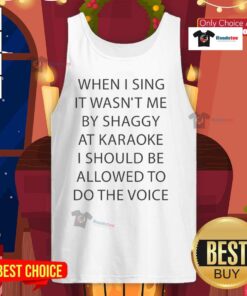 Person in a tank top singing 'It Wasn't Me' by Shaggy at karaoke, showcasing their fun performance and enthusiasm.
