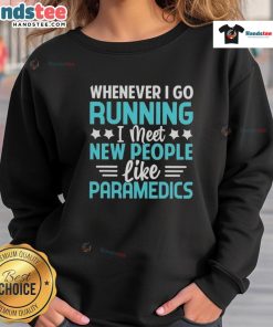 Person wearing a 'Good Whenever I Go Running, I Meet New People Like Paramedics' sweatshirt while jogging in a park.