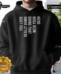 Person wearing a hoodie with 'Good You Look Really Dumb Doing That' graphic, striking a playful pose.