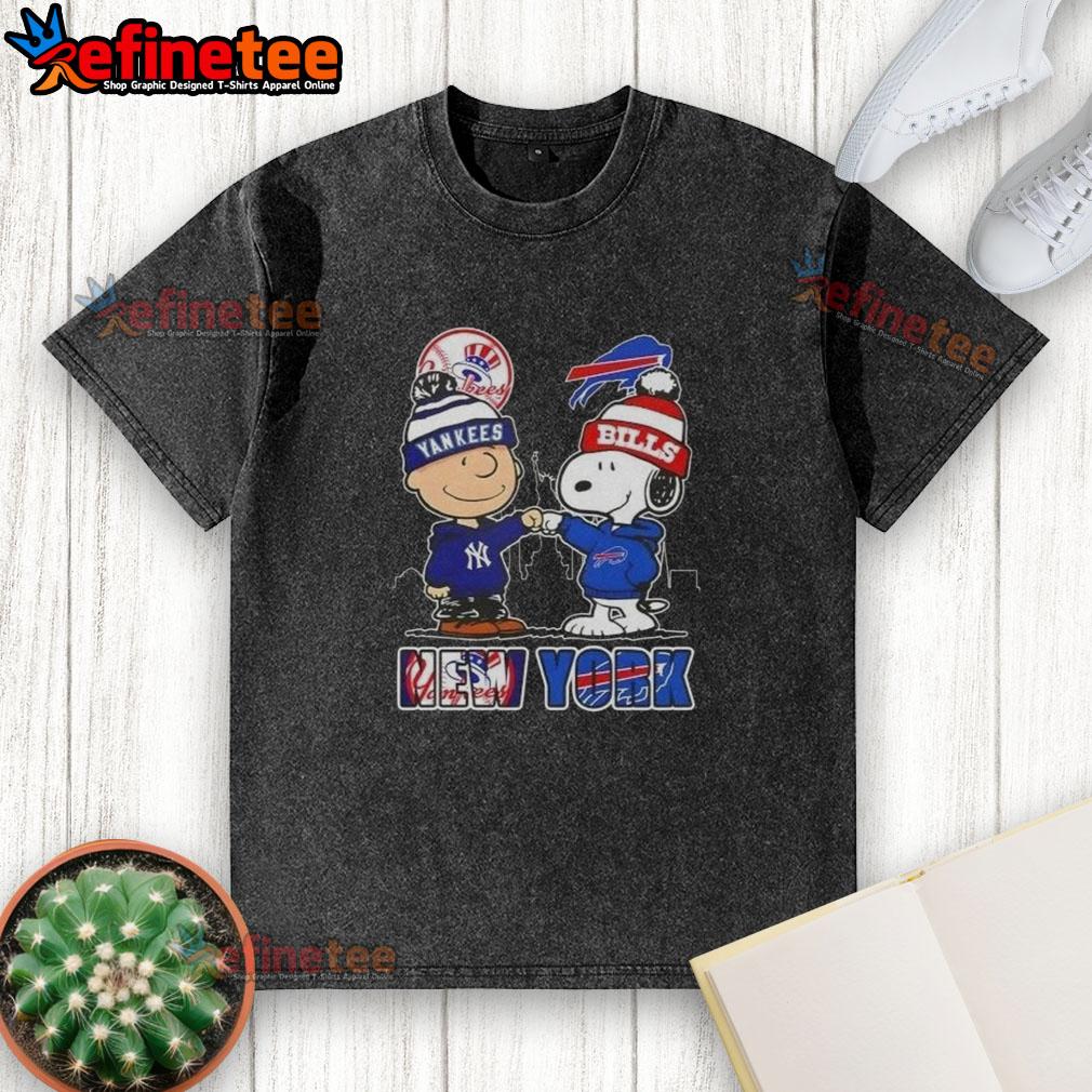 Happy Charlie Brown New York Yankees x Snoopy Buffalo Bills Skyline Washed T-Shirt Happy Charlie Brown New York Yankees x Snoopy Buffalo Bills skyline washed t-shirt featuring iconic characters and cityscape.