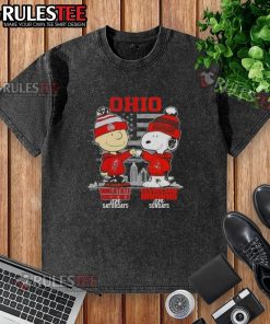 Happy Charlie Brown in Ohio State Buckeyes tee and Snoopy in Cleveland Browns shirt against a skyline backdrop.
