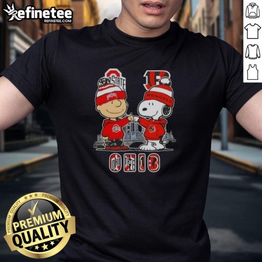 Happy Charlie Brown in Ohio State Buckeyes and Snoopy with Cincinnati Bengals skyline on a fun graphic tee.