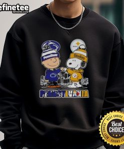 Alt Text: Happy Charlie Brown in a Penn State Nittany Lions x Snoopy Pittsburgh Steelers skyline sweatshirt.