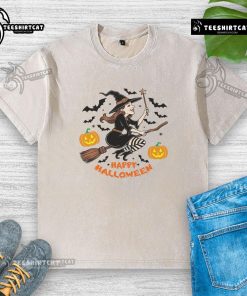 Happy Halloween witch flying on broomstick graphic on a washed t-shirt, perfect for festive celebrations.