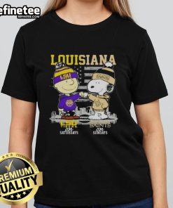 Alt Text: Happy Louisiana sports tee featuring Charlie Brown, LSU Tigers, and New Orleans Saints skyline design for ladies.