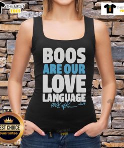 Happy fan wearing a Philadelphia Phillies tank top with 'Boos Are Our Love Language' slogan, showcasing team spirit.