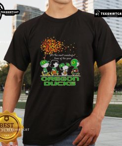 Alt Text: Happy Snoopy and friends on Oregon Ducks autumn t-shirt celebrating the sports team's festive spirit.