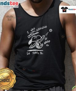 Happy Snoopy wearing a tank top while swinging in York, capturing a joyful moment in a colorful outdoor setting.