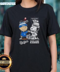 Hot Snoopy and Charlie Brown in Dodgers and Raiders skyline design on a stylish ladies tee shirt.