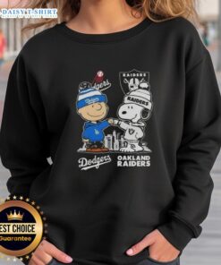 Alt Text: Hot Snoopy and Charlie Brown Los Angeles Dodgers x Las Vegas Raiders skyline sweatshirt design featuring iconic characters.