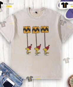 Funny Hot Woodstock Peanuts Christmas details on yellow and black Charlie Brown washed t-shirt for festive style.