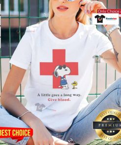 Ladies tee featuring Snoopy and American Red Cross slogan 'A Little Goes A Long Way - Give Blood' with peanuts theme.