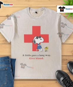 Alt Text: American Red Cross peanuts Snoopy t-shirt promoting blood donation with 'A Little Goes A Long Way' slogan.