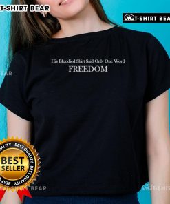 Alt Text: Charlie Kirk wearing a bloodied shirt with the word 'Freedom' on a stylish ladies tee, promoting liberty and resilience.