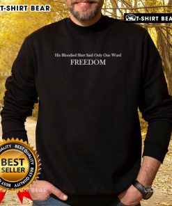 Charlie Kirk wearing a bloodied shirt with 'Freedom' on his sweatshirt, symbolizing a powerful message.