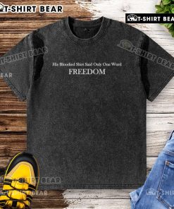 Alt Text: Charlie Kirk wearing a bloodied Freedom washed T-shirt, symbolizing resilience and the fight for liberty.
