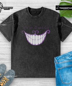 Cheshire Cat smile on a washed t-shirt with 'We Are All Mad Here' text, perfect for whimsical fashion lovers.