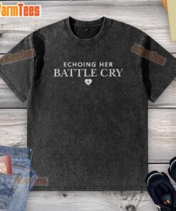 Erika Kirk in a washed T-shirt, passionately echoing her battle cry during a vibrant outdoor event.