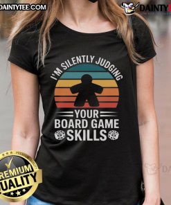 Adults enjoying a fun game night with board games, featuring ladies wearing themed tees for a cozy atmosphere.