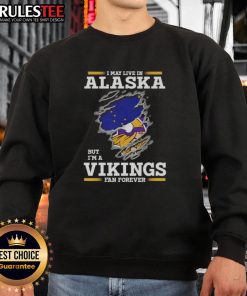 Cozy sweatshirt featuring 'I May Live In Alaska But I'm A Minnesota Vikings Fan Forever' design, perfect for NFL fans.