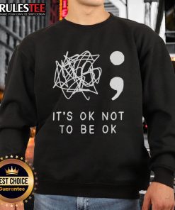 Alt Text: Cozy 'It's Okay to Not Be Okay' sweatshirt in a casual setting, perfect for comfort and self-expression.