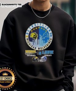 Alt Text: Cozy sweatshirt featuring Nice Michigan Wolverines and Detroit Lions helmets against a skyline backdrop.