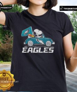 Alt Text: Philadelphia Eagles flag featuring Snoopy and Woodstock driving a car on a ladies tee, perfect for fans.