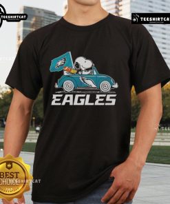 Alt Text: Philadelphia Eagles flag t-shirt featuring Snoopy and Woodstock driving a car, perfect for football fans.