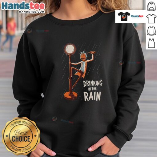 Rick from Rick and Morty wearing a sweatshirt, enjoying a drink in the rain, showcasing the Nice Rick Drinking design.