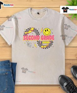 Alt Text: Retro smiley face design on a second-grade back-to-school washed t-shirt featuring a skateboard and pencil.