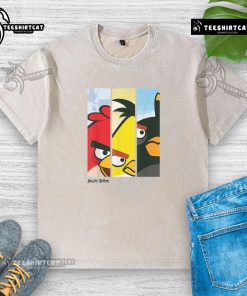 Alt Text: Retro Angry Birds character face panel design on a washed t-shirt featuring red, yellow, and black birds.