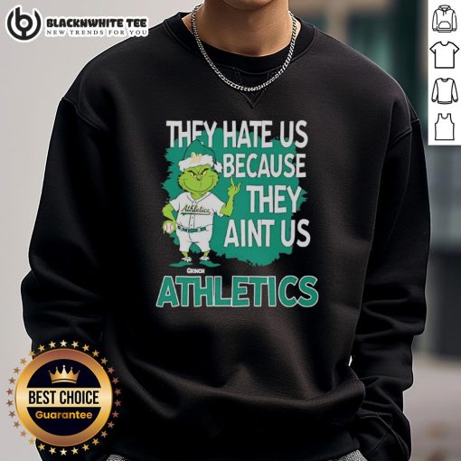 Official Athletics Grinch Christmas sweatshirt featuring 'They Hate Us Ain't Us' design for festive sports fans.