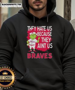 Alt Text: Official Atlanta Braves Grinch Christmas hoodie featuring They Hate Us, Ain't Us slogan for festive fans.