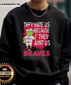 Official Atlanta Braves Grinch Christmas sweatshirt featuring 'They Hate Us Ain't Us' design for holiday fans.