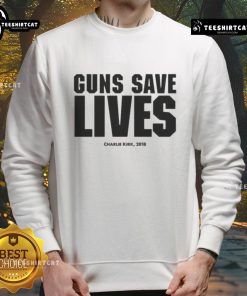 Charlie Kirk wearing a 'Guns Save Lives' sweatshirt at an event, promoting gun rights and conservative values in 2018.