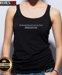 Alt Text: Charlie Kirk wearing a bloodied shirt with the word Freedom on a tank top, symbolizing his advocacy for liberty.