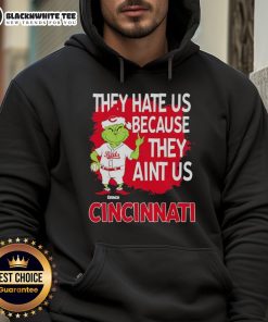 Official Cincinnati Reds Grinch Christmas hoodie featuring 'They Hate Us Ain't Us' design for festive fans.
