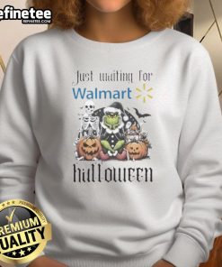 Official Grinch Halloween sweatshirt waiting for Walmart shoppers, featuring festive design for holiday fun.