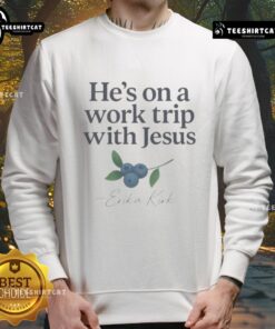 Alt Text: Erika Kirk wearing a faith-based Christian sweatshirt, 'He's On A Work Trip With Jesus,' showcasing stylish comfort.