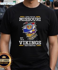 Alt Text: Official 'I May Live In Missouri But I'm A Minnesota Vikings Fan Forever' T-Shirt showcasing team spirit and pride.
