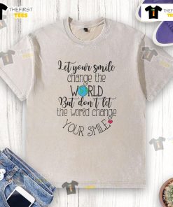Official inspirational quote on a washed t-shirt: 'Let Your Smile Change The World' promoting positivity and kindness.