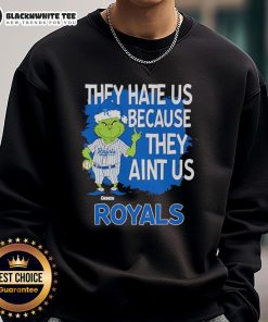 Alt Text: Official Kansas City Royals Grinch Christmas sweatshirt featuring 'They Hate Us Ain't Us' slogan, perfect for holiday fans.