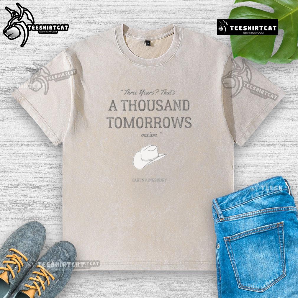 Official Karen Kingsbury Bookstore A Thousand Tomorrows Washed T Shirt Alt Text: Official Karen Kingsbury Bookstore A Thousand Tomorrows washed t-shirt featuring a soft design for fans.