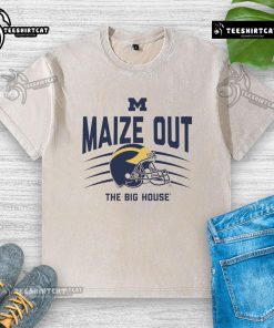 Alt Text: Official Michigan Wolverines maize out scratch helmet washed T-shirt displayed on a wooden background.