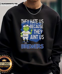 Official Milwaukee Brewers Grinch Christmas sweatshirt featuring 'They Hate Us Ain't Us' design for fans.