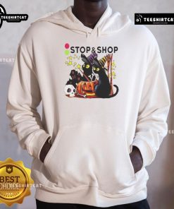 Alt Text: Black cat witch with a pumpkin in front of a haunted house on the Official Stop And Supermarket Halloween hoodie.