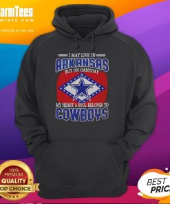 Fan wearing I May Live In Arkansas But On Gameday My Heart Belongs To Dallas Cowboys hoodie, showcasing team spirit.