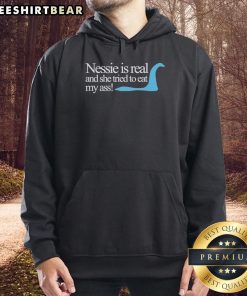 Original Loch Ness Nessie Is Real hoodie featuring a playful design of Nessie humorously attempting to eat.