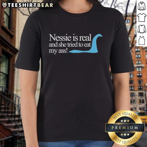 Original Loch Ness Nessie Is Real tee featuring a humorous design of Nessie trying to eat a person, perfect for fans.